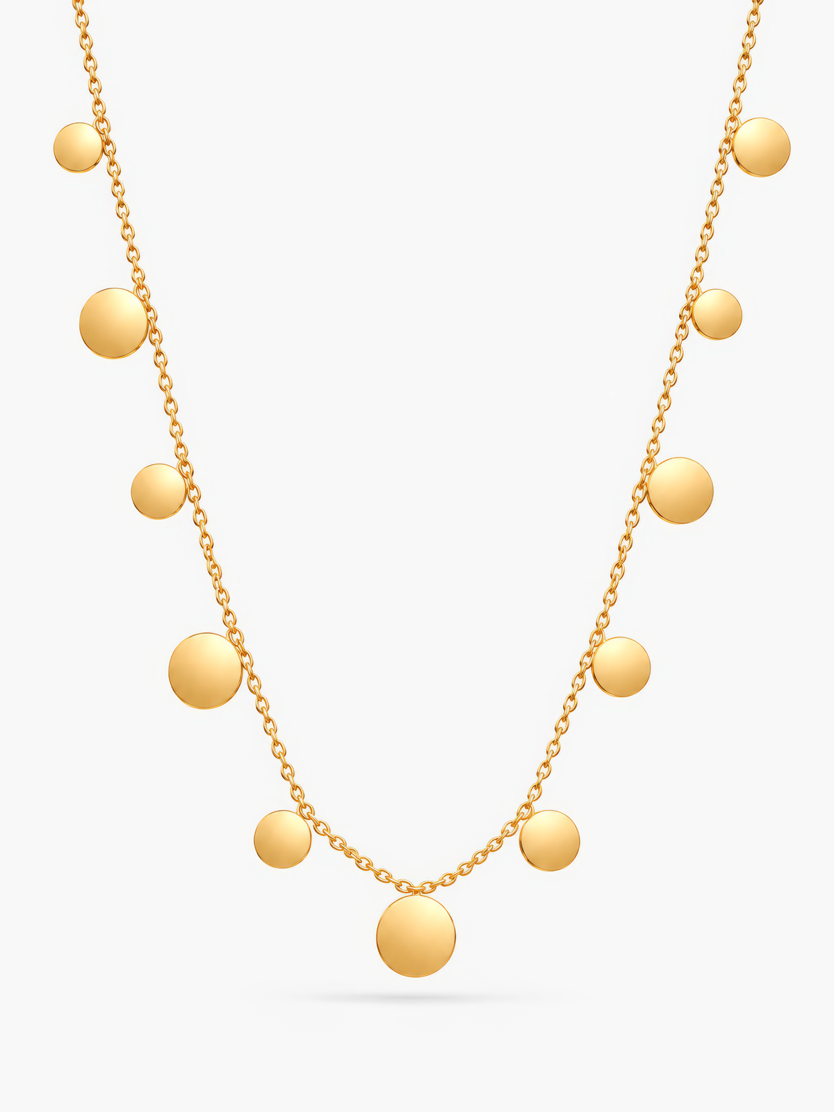 Goldene Lyra Plättchenkette von Mercy’s Jewelry mit runden Plättchen vor hellgrauem Hintergrund.