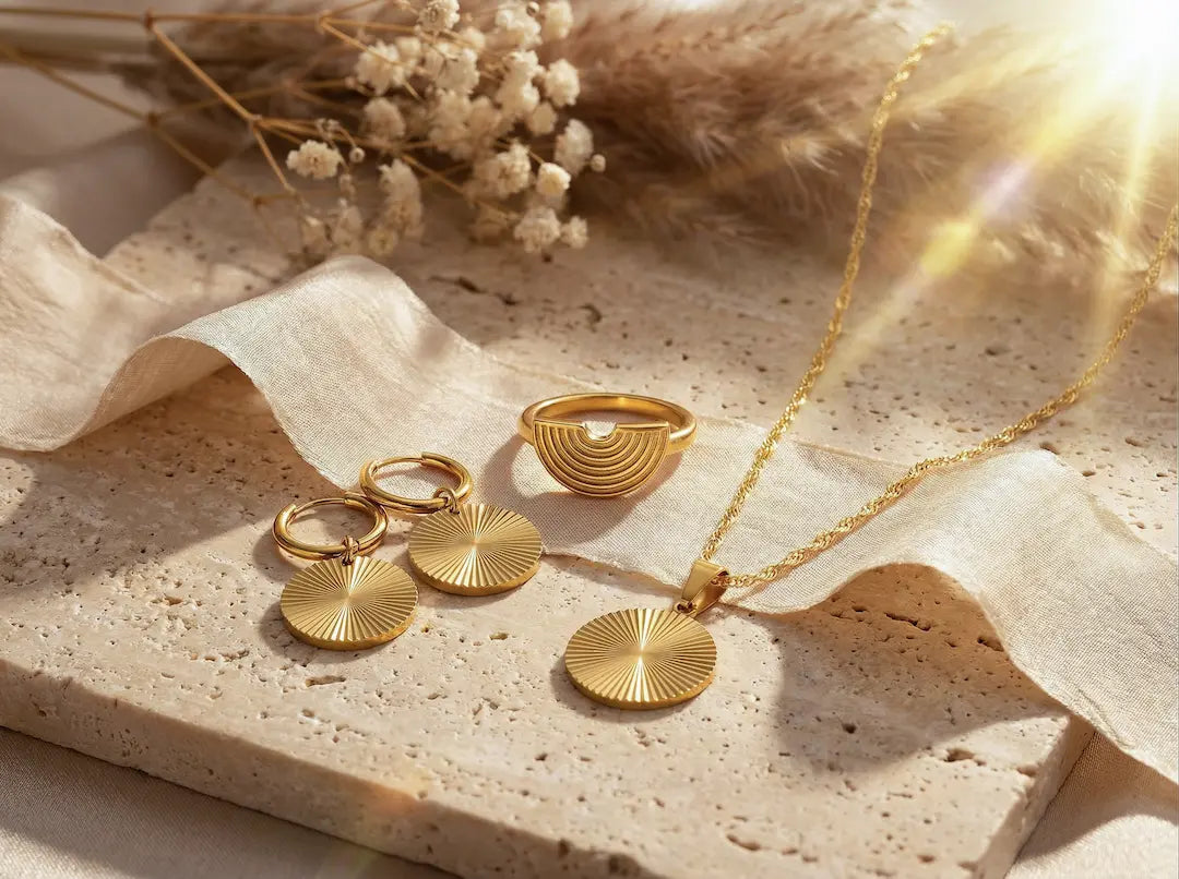 Ästhetisches goldenes Schmuck-Set von MERCYS: Halskette mit rundem Sonnen-Anhänger, passende Creolen und ein strukturierter Ring auf bymercy.de.
